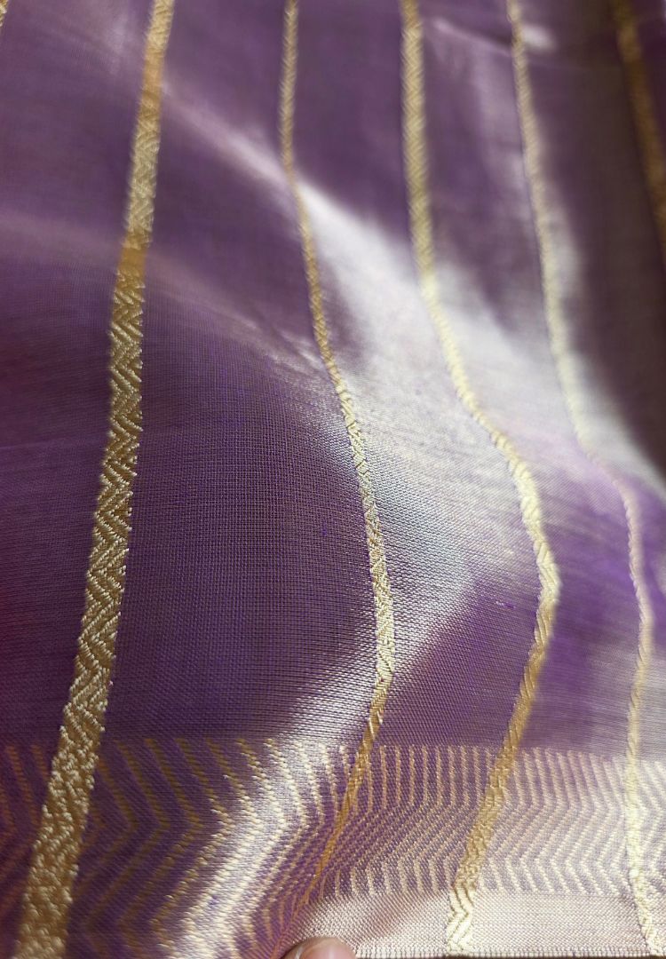 Luminous sheen of a lavender katan tissue saree in daylight