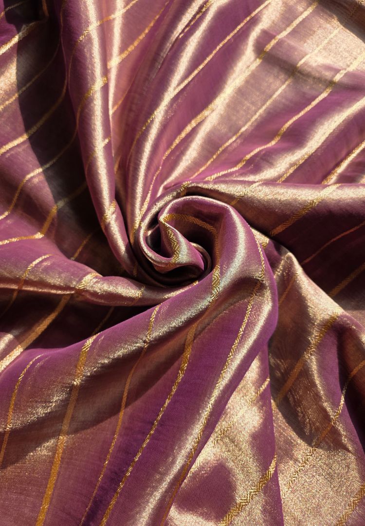 Close-up of gold zari weave on a lavender tissue saree