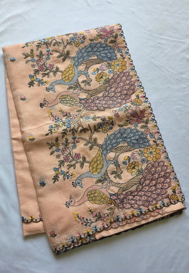 Folded Pastel Peach Gulbahar soft Kota saree with hand embroidered peacock pallu