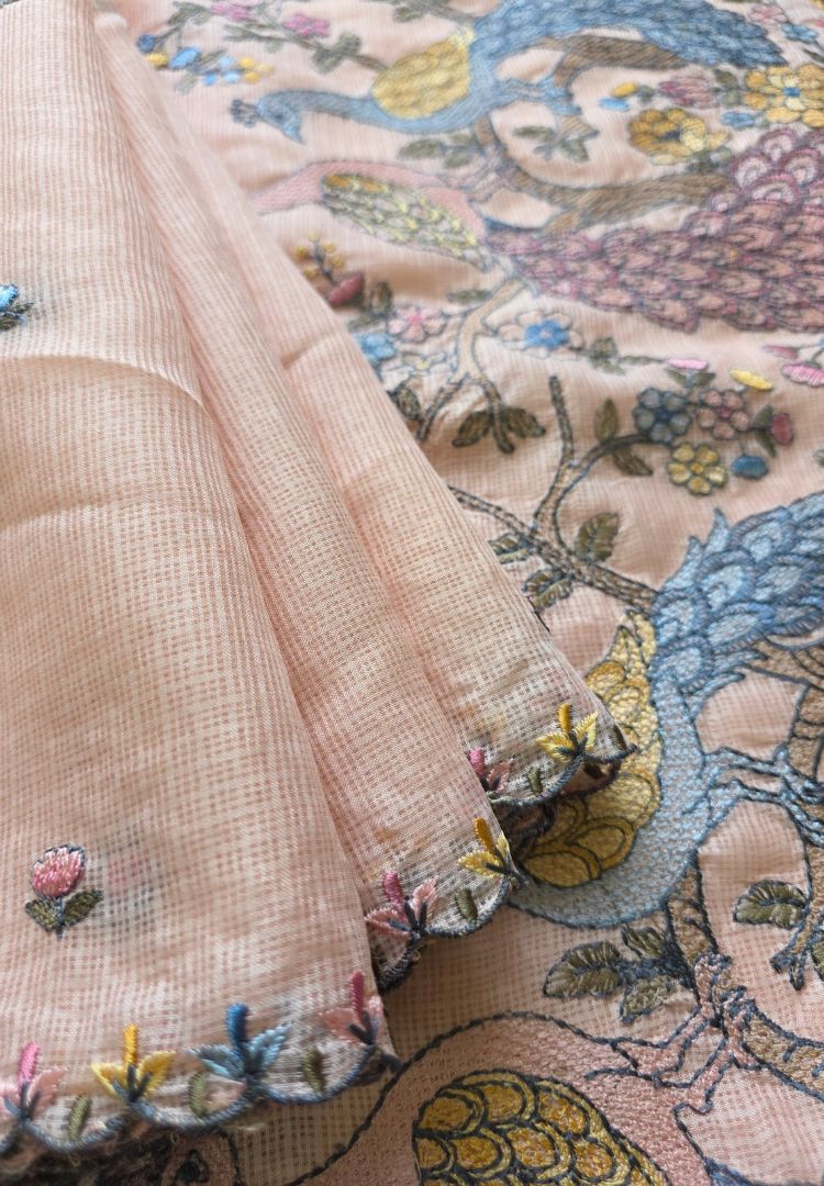 Pink, green and blue hand embroidery detail on a lightweight soft Kota saree