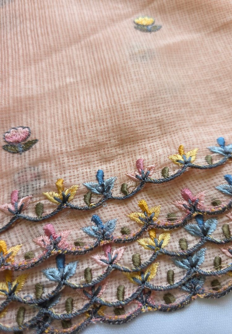 Feather-light pastel peach Kota saree with hand embroidered peacock motifs for festive wear