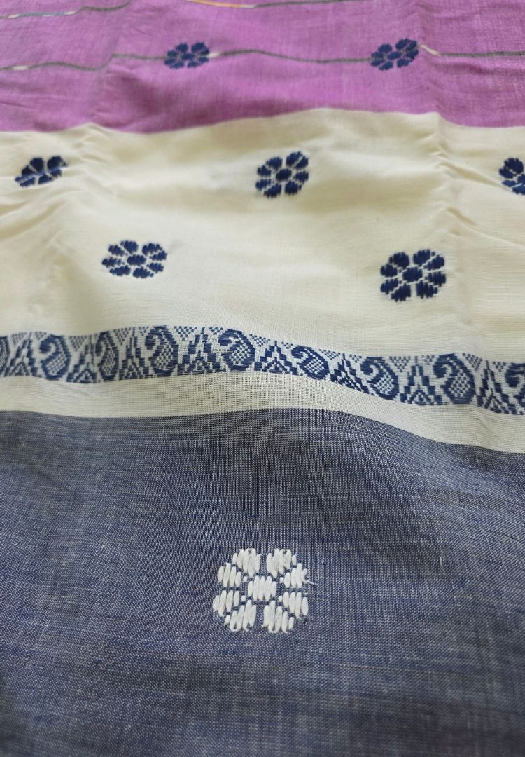 Close-up of Ikkat motifs on a purple and white Dhaniakhali cotton saree
