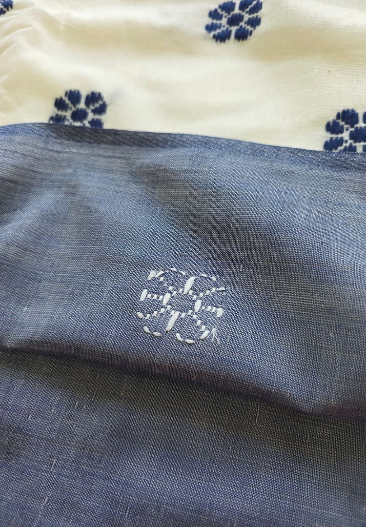 Pallu detail of a purple, white and grey Ikkat Dhaniakhali saree