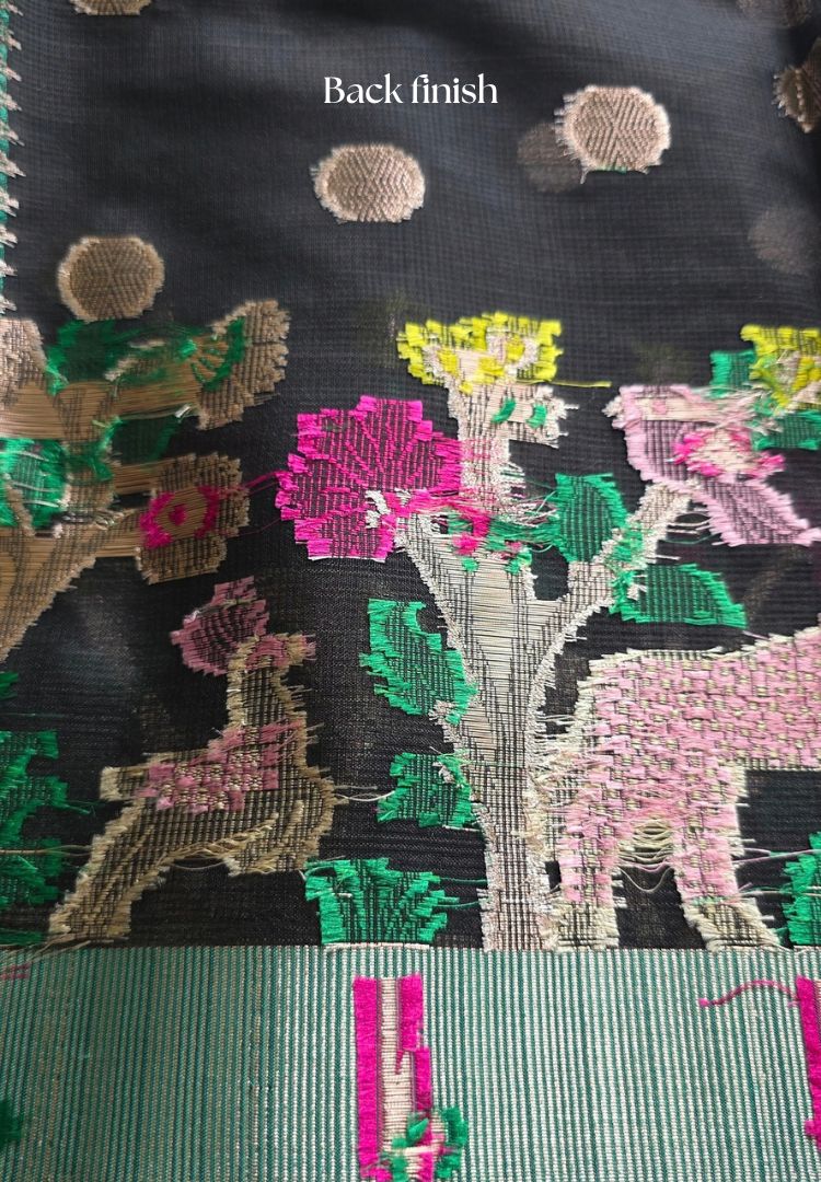 Close-up of woven deer and pink flowers on the black and teal Kota silk saree