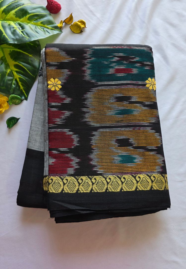 Folded silver grey and black Dhaniakhali handloom cotton saree showing Ikkat pallu and golden border
