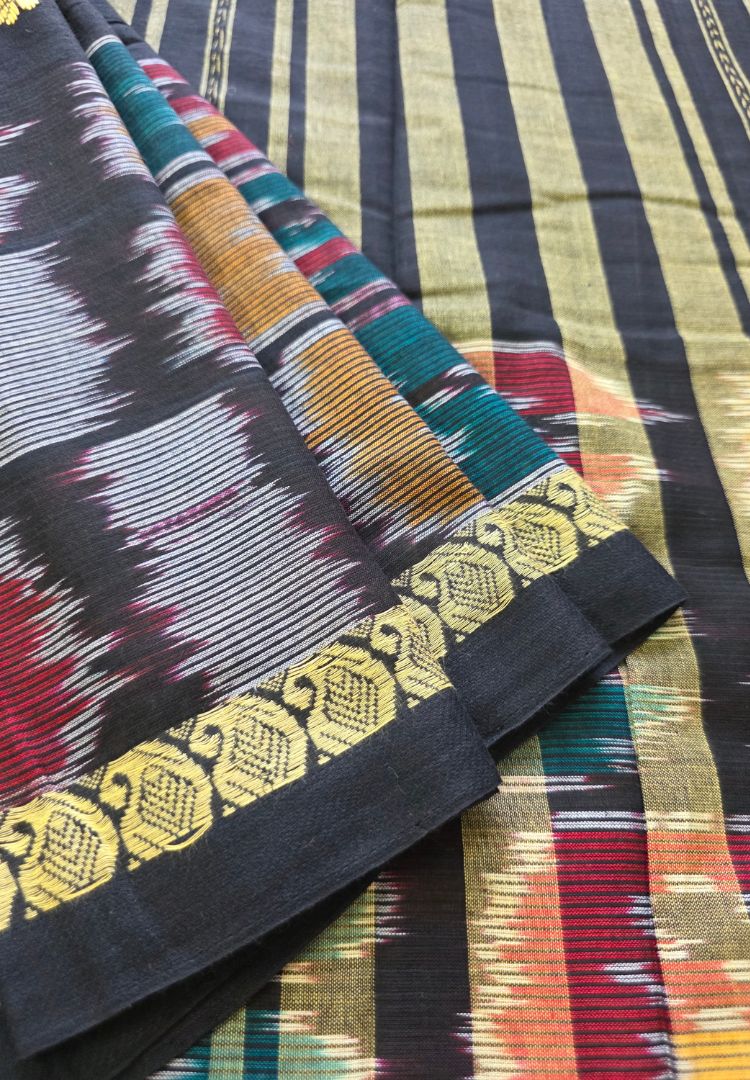 Close-up of colourful Ikkat weaving on the black pallu of a Dhaniakhali cotton saree