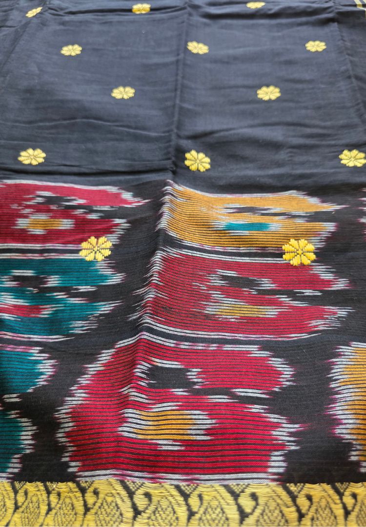 Detail of Ikkat motifs and thread buttis on a black and grey Dhaniakhali handloom saree
