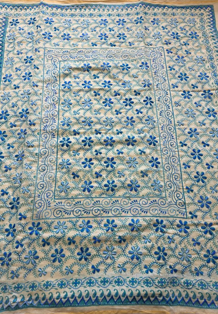 Teal blue hand embroidered pallu and border of the Ivory and Teal Blue Gulbahar Chanderi saree