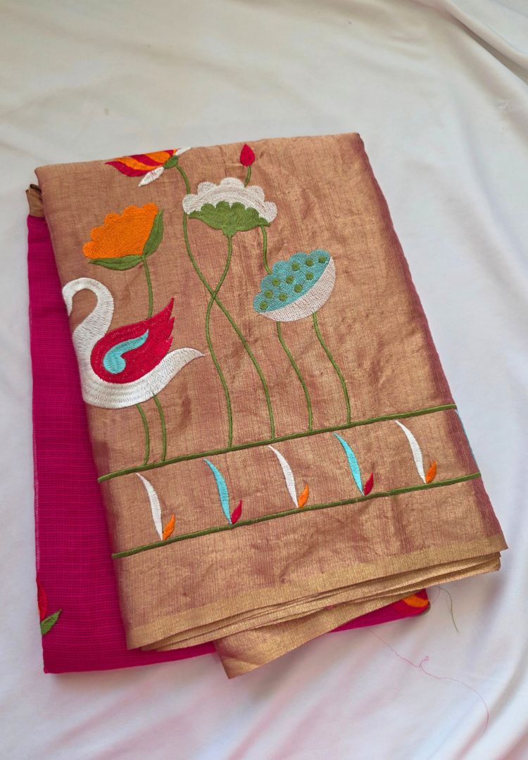 Folded Fuchsia Pink and Gold Kota zari saree showing the embroidered swan pallu