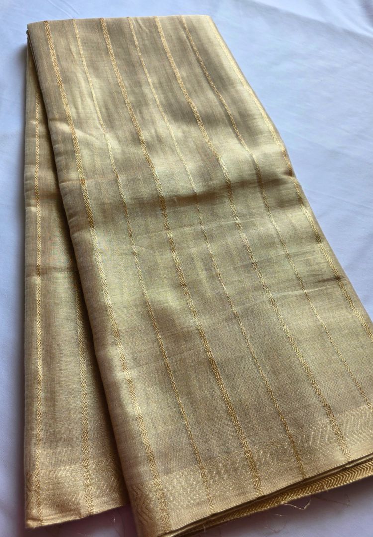 Chevron zari border and stripes on an ivory gold katan tissue saree