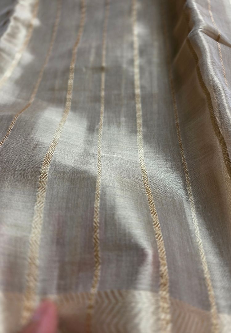 Fine zigzag zari stripes on an ivory gold katan tissue saree