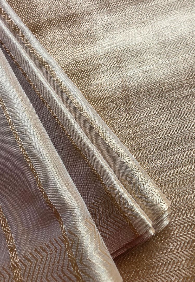 Soft drape and sheen of an ivory gold katan tissue saree