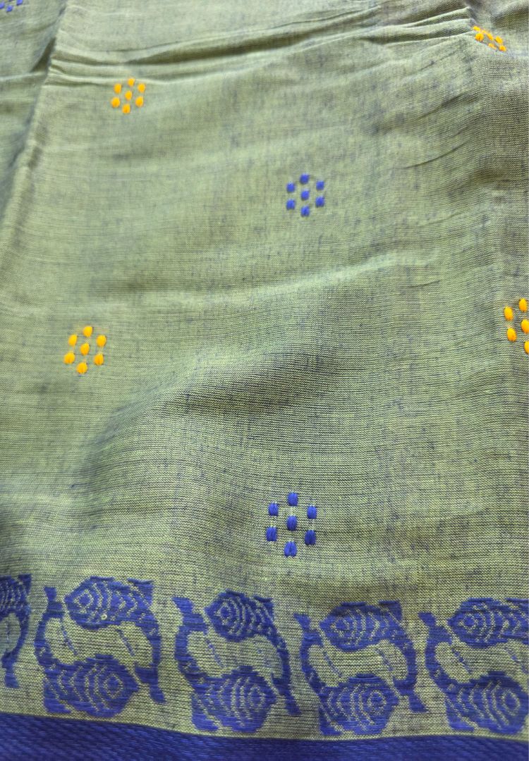 Close-up of buttis and royal blue Ikkat border on a jade green Dhaniakhali cotton saree