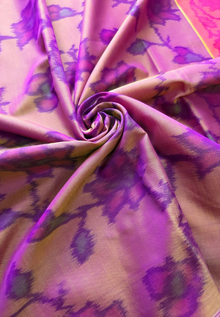 Soft flowy drape of a gold and purple Ikkat semi katan silk saree