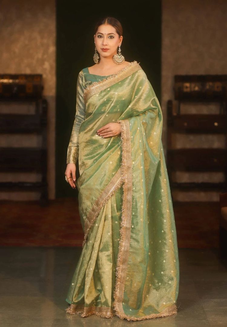 Woman wearing the Mint Green metallic Banarasi tissue saree with gold lace border - Silk Ethnics