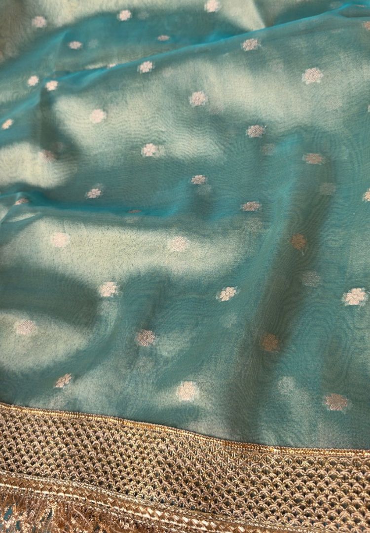 Zari butis on shimmering mint green Banarasi tissue with lace border