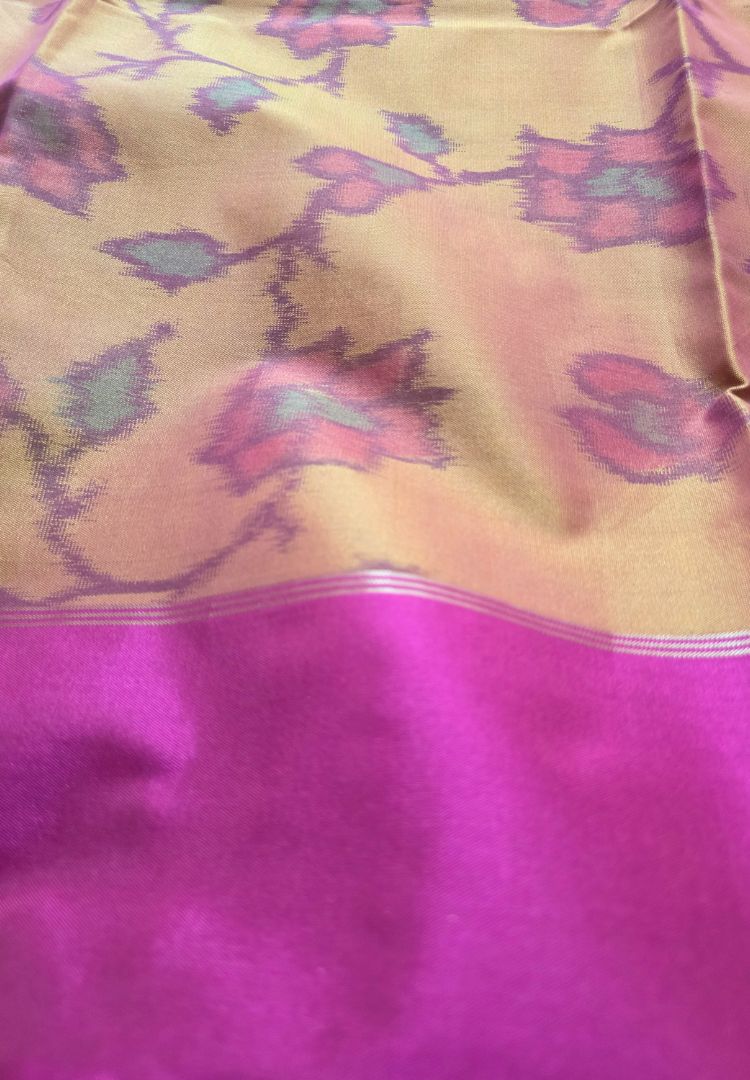 Close-up of purple Ikkat floral jaal on a mustard gold semi katan silk saree