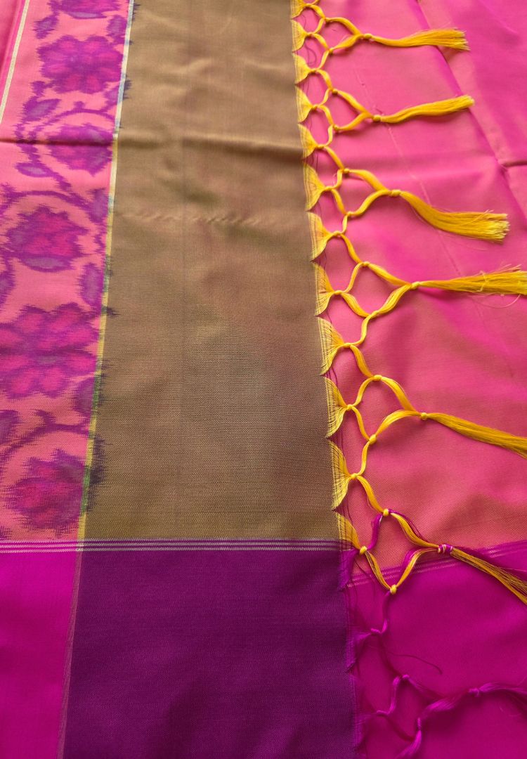 Handcrafted tassels on the rani pink pallu of a mustard Ikkat silk saree