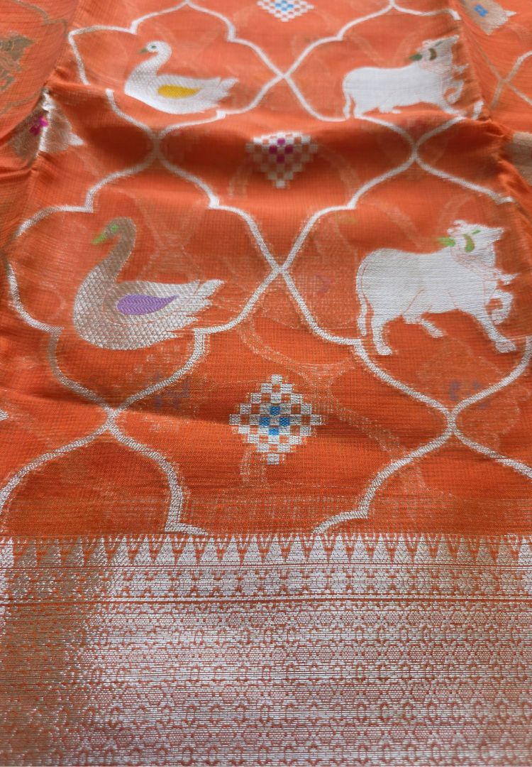 Pichwai cow motifs woven in zari within a trellis on orange Kota silk