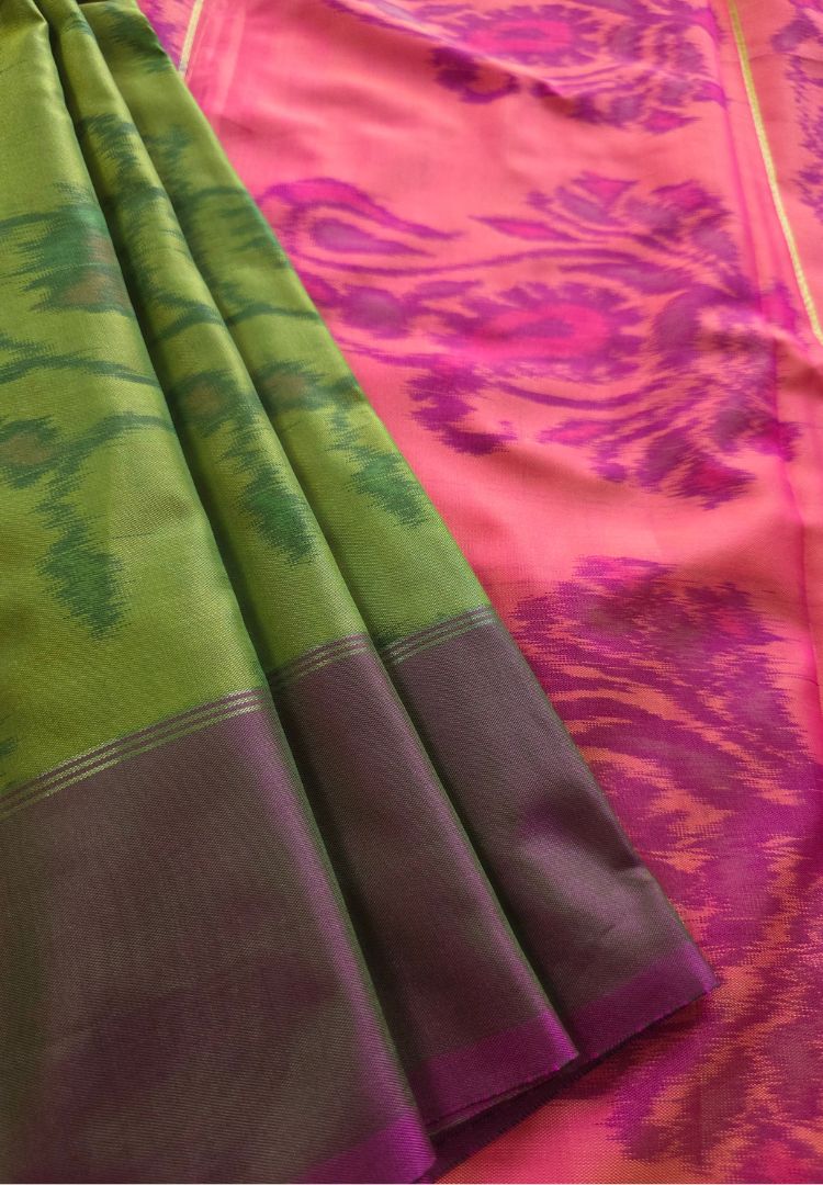 Pleats of a parrot green Ikkat semi katan silk saree with rani pink pallu