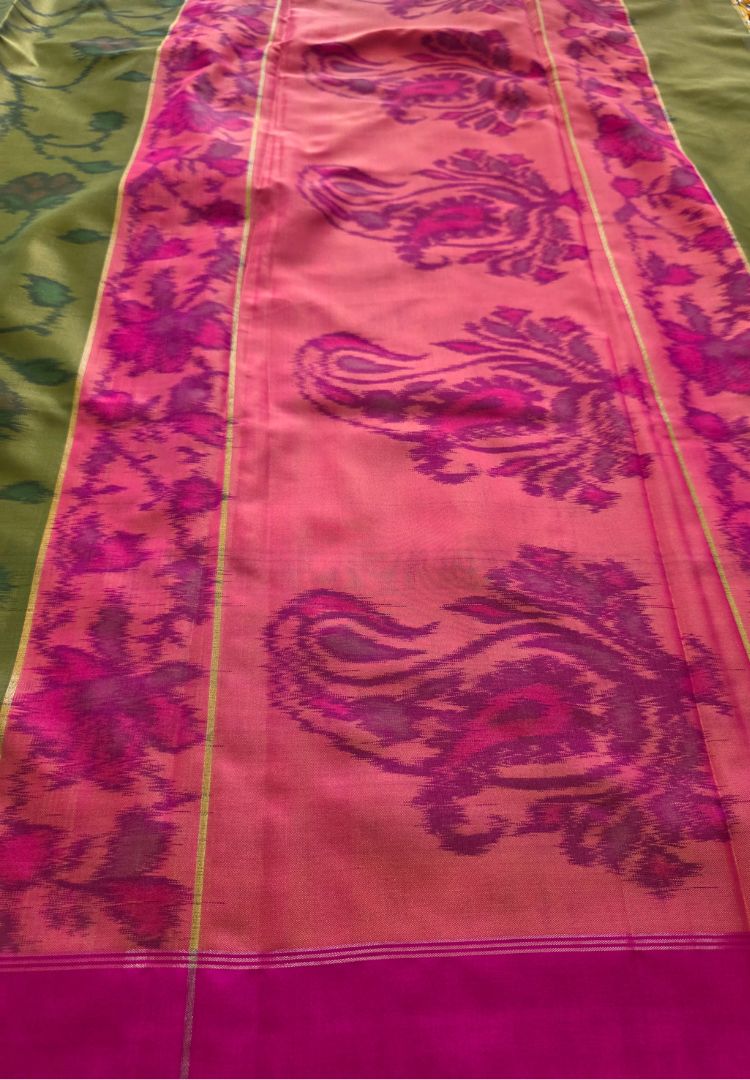 Rani pink pallu with wine Ikkat paisley motifs on a semi katan silk saree