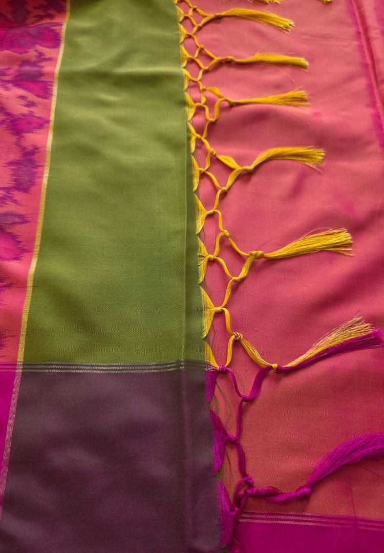 Handcrafted tassels and pink pallu of a parrot green Ikkat silk saree