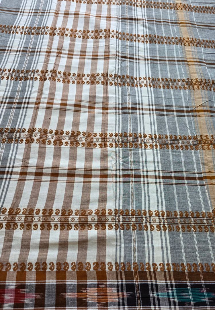 Close-up of woven stripes and Ikkat bands on a grey Dhaniakhali saree